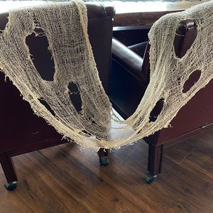 Gauzy spiderweb decor approximately 18 x 100”